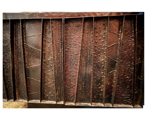 A detailed close-up of a Paul Evans Deep Relief credenza, Model PE-42.