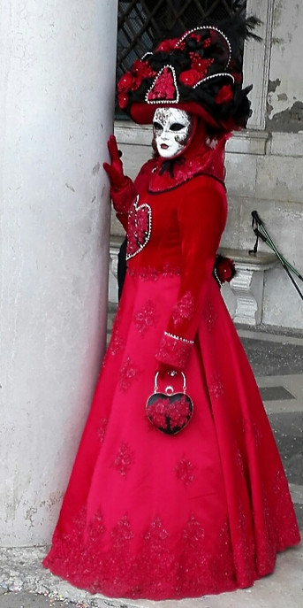 Striking vivid red costume at Venice Carnival.