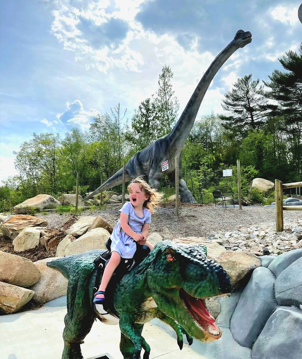 Photo op on raptor dinosaur in front of Brachiosaurus