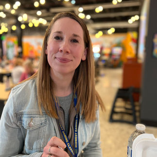 Woman sits in food court ready to eat
