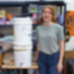 Hey Kiddo Co. stood next to homemade water filtration system for Jesmonite AC100