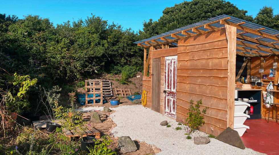 Shower besides the wooden field kitchen