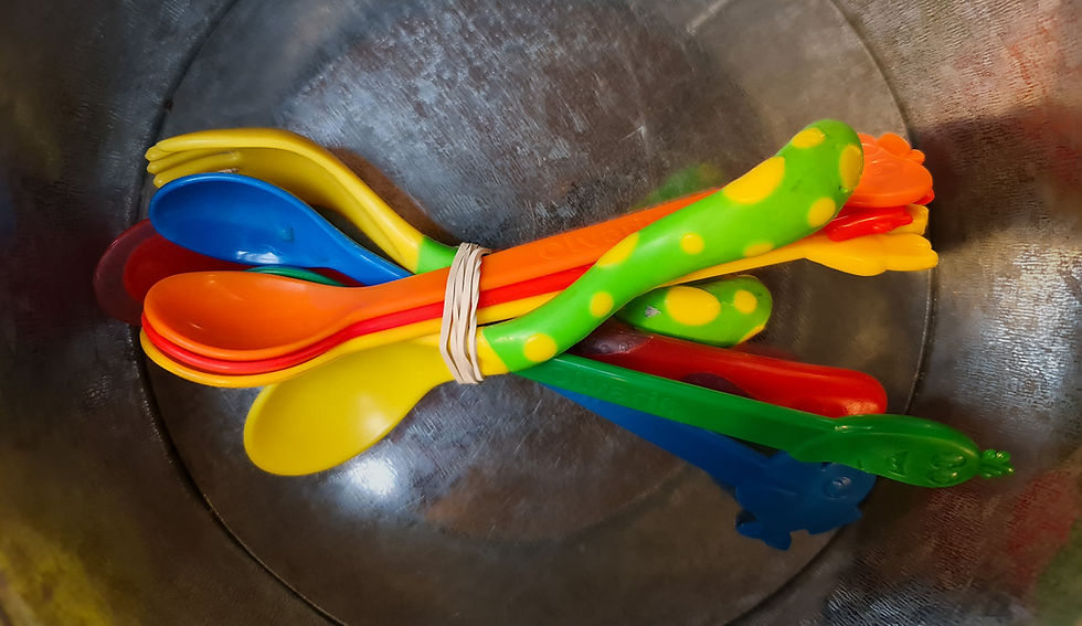 A bundle of teaspoons resting together, unused, in a metal container.referring to theelepeltjes, a poem of Annie M.G. Schidt 