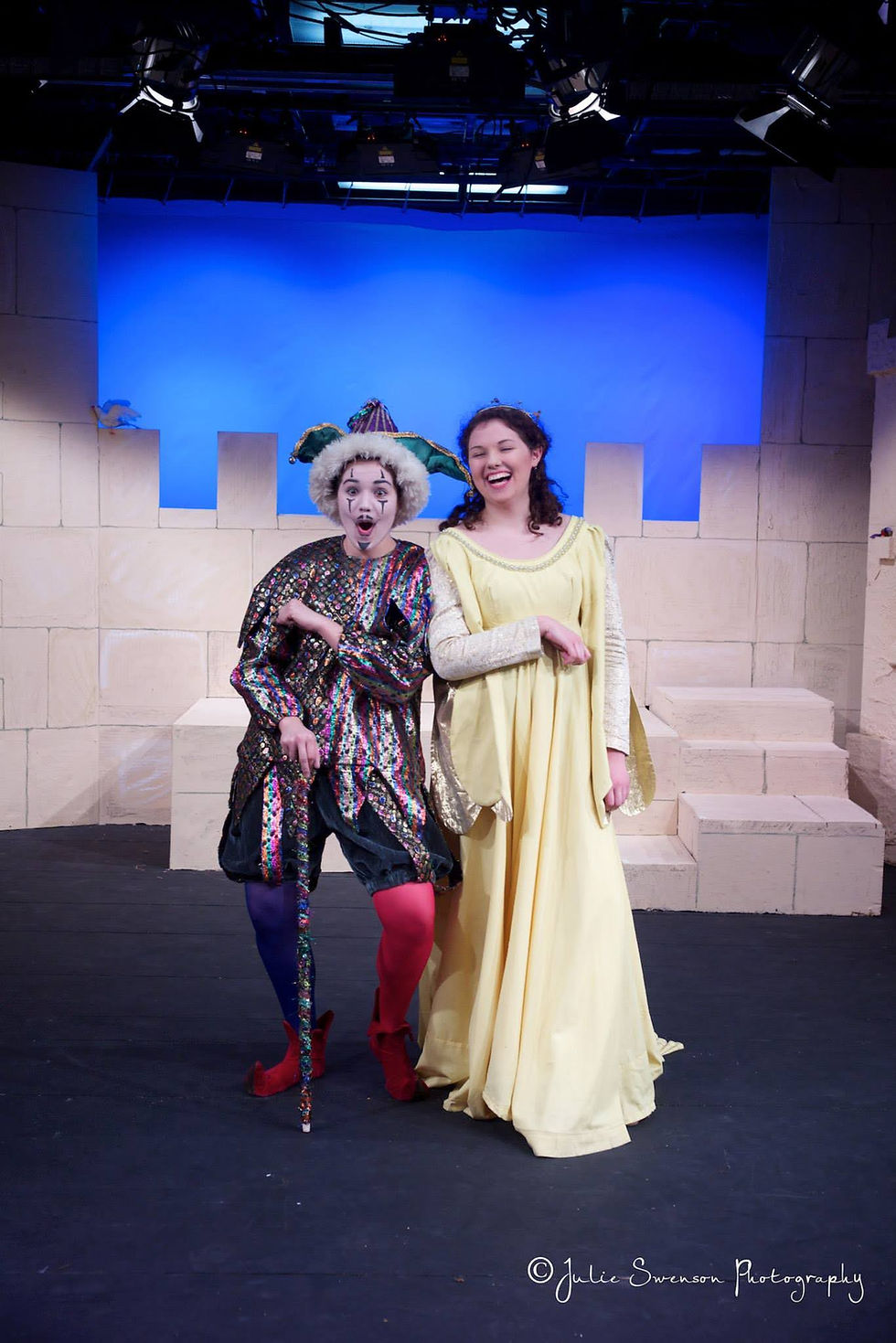 Olivia laughing with a jester as "Winnifred"