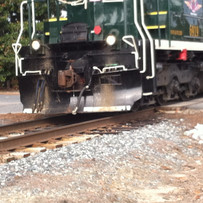 Railroad track installed with pressure treated wooded rail ties for long-lasting structural support and durability.