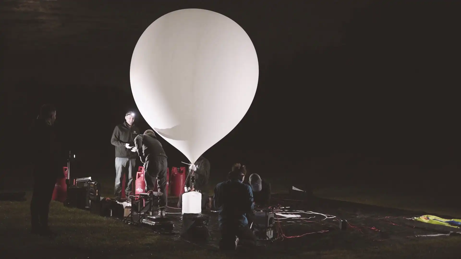 High-altitude balloon being filled by the Sent Into Space launch team at night
