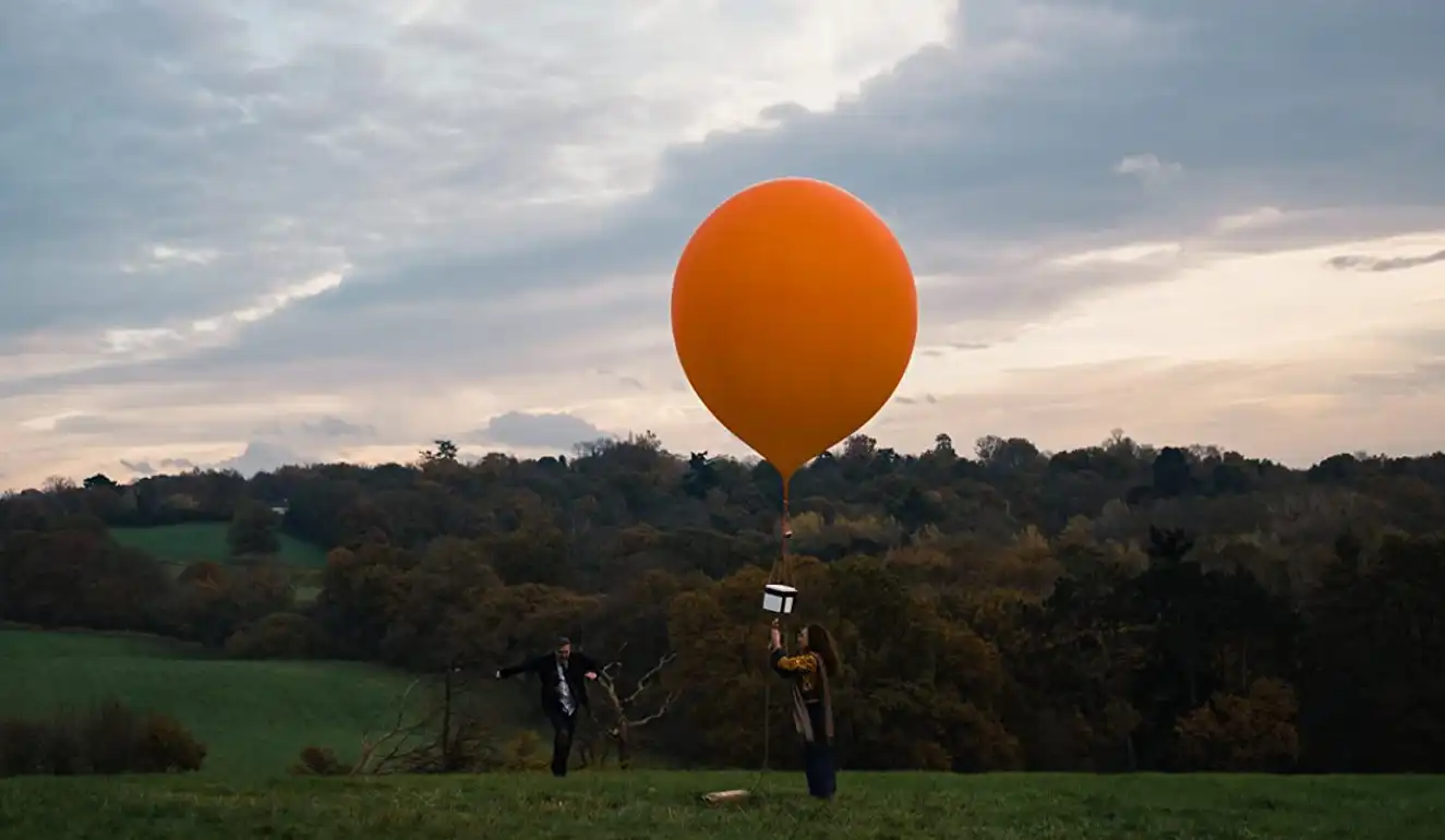 space scatting memorial with orange balloon from the short film Pops