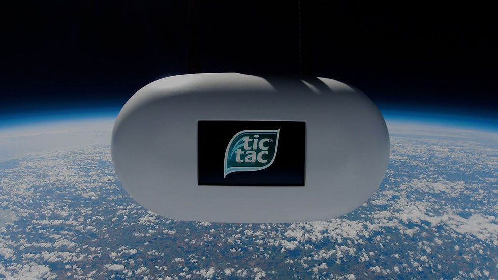 TicTac shaped spacecraft in space with Earth below