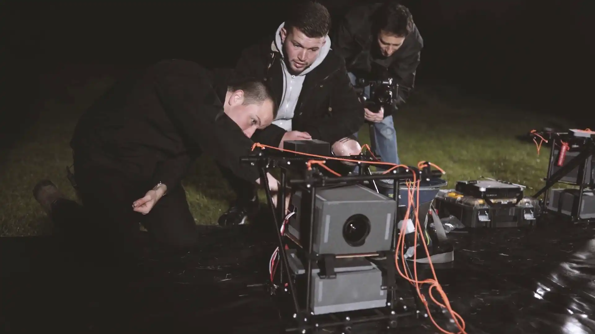 Sent Into Space creative team and engineers working together during final checks on a spacecraft at night