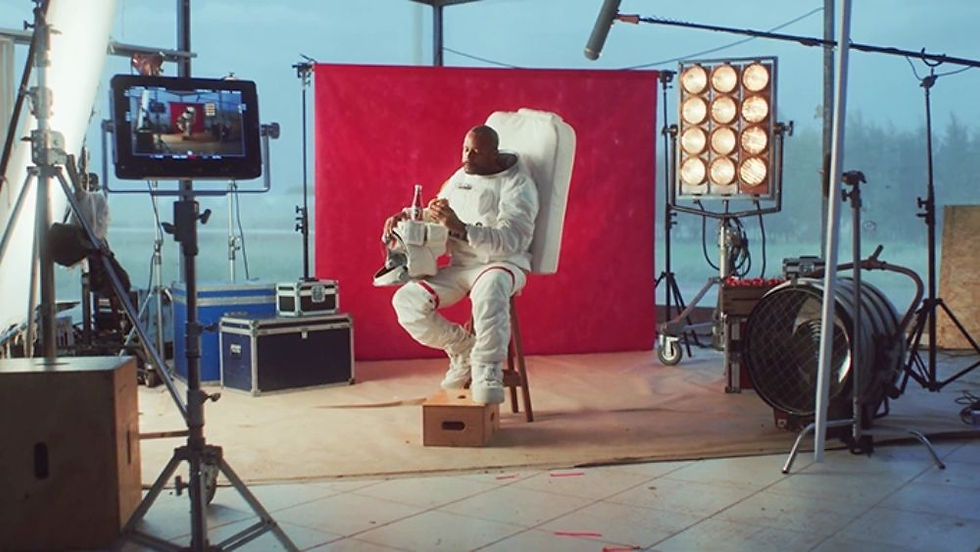 Man wearing an astronaut suit sitting on a film set
