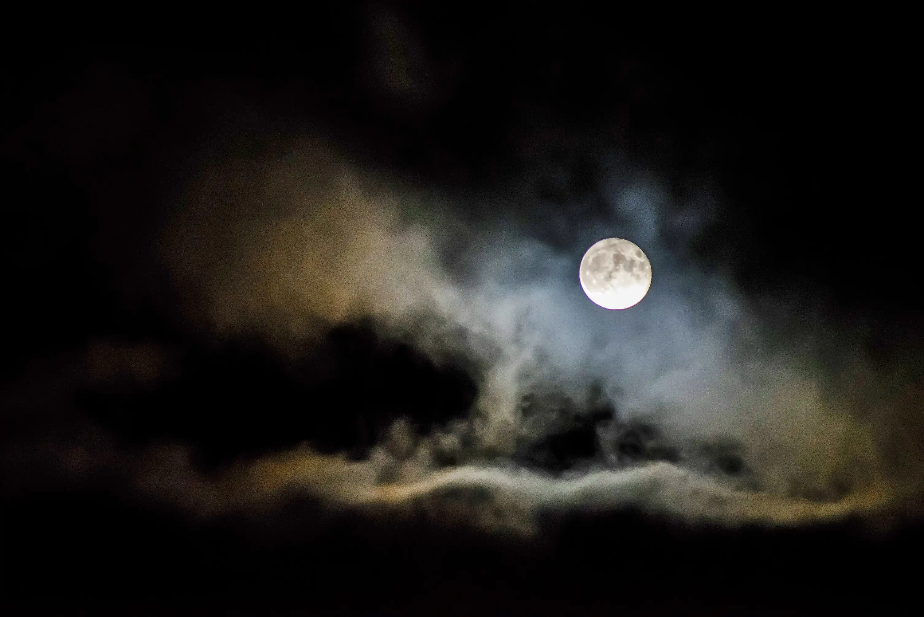 Clouds illuminated by a full moon