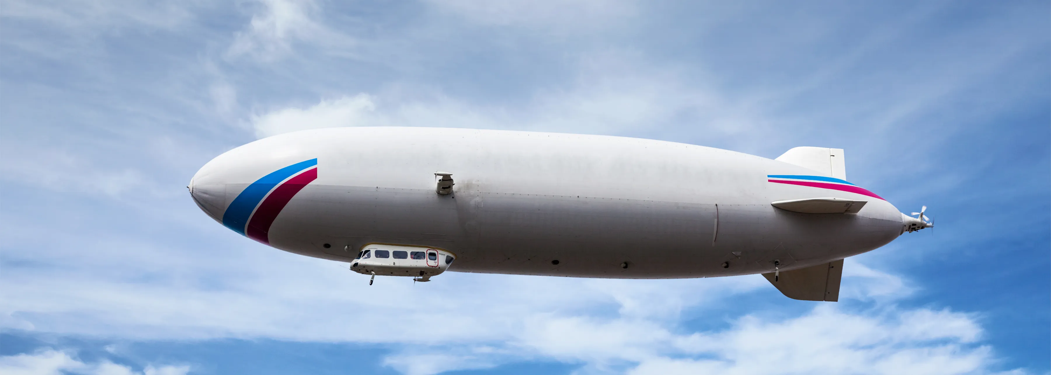 A large modern white airship in flight