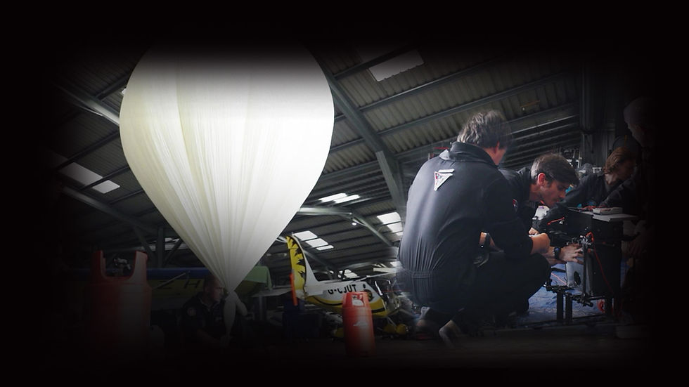 Sent Into Space launch team preparing to launch from an aircraft hangar with high-altitude balloon the background.