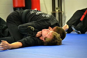 Two students grappling on the dojo mat