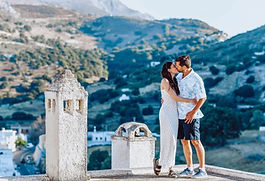 Photo source: https://www.naxosphotographer.com/ 4. Naxos, Greece The thought of Naxos it stirs my soul like a love letter written by the gods themselves. I see us there, two wanderers wrapped in the island’s timeless magic, footsteps echoing along sun-drenched marble and cobblestones, hearts beating in sync with the gentle waves of the Aegean. Our days would begin at the Portara, that majestic marble doorway standing alone on the edge of the sea; an ancient portal to a world where love stories never end. Imagine us standing there as the sun rises, the sky bursting into shades of pink and gold, the breeze carrying whispered promises only we can hear. Later, we’d lose ourselves in the labyrinth of Naxos Town, its narrow alleys lined with whitewashed houses and colourful bougainvillea, every corner a new secret waiting to be discovered. We’d wander to the Venetian Castle (Kastro), perched high above the town, where the view of the endless sea feels like the world itself is holding its breath for us. Afternoons call for lazy hours on the golden sands of Plaka Beach, where the turquoise water invites us to dive in, and the warm sun seems to wrap us in a gentle embrace. Perhaps we’d take a boat to the secluded island of Delos, a sacred place steeped in myth, where the echoes of ancient love stories linger in the air, inspiring ours to grow even deeper. As twilight falls, the village of Halki beckons with its cobblestone streets and quaint tavernas. We’d share a bottle of local wine beneath a canopy of stars, the soft strum of a bouzouki weaving a soundtrack just for us. In Naxos, every moment feels like a chapter in a romance novel — vivid, tender, and endlessly beautiful.