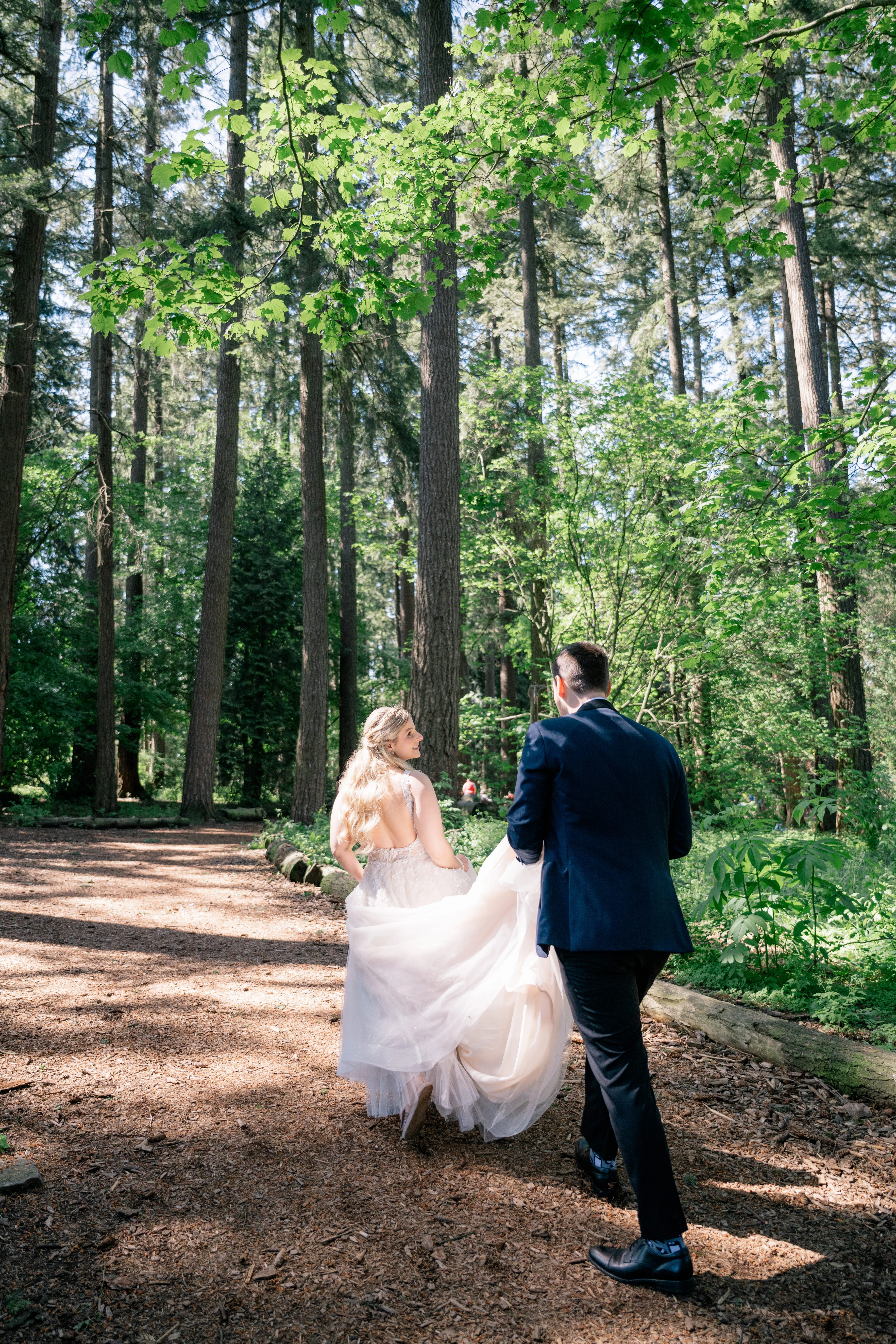 Bride and groom exuding fairy tale vibes in a lush forest, looking like they stepped straight out of a storybook
