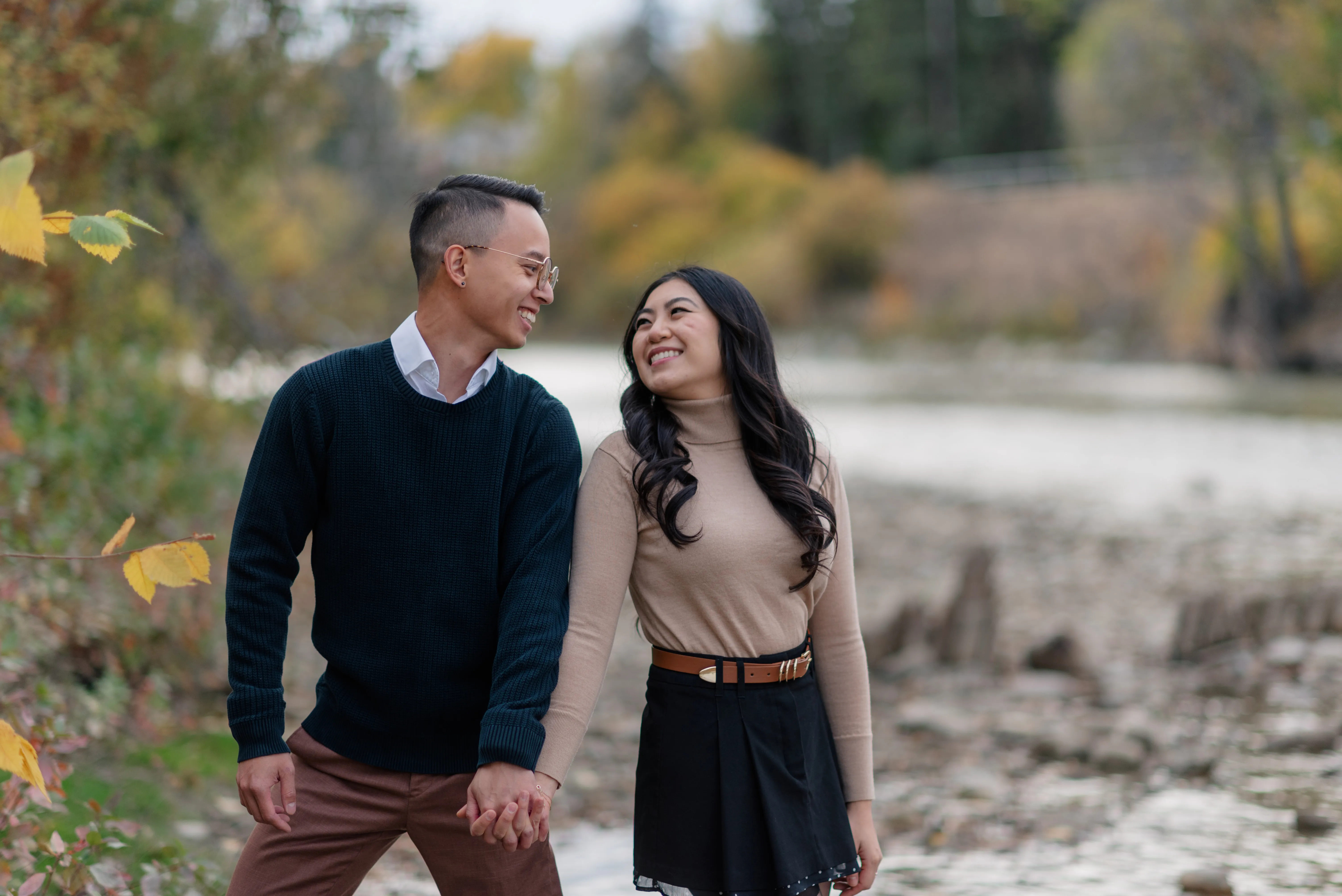 Romantic engagement portrait of couple embracing by Elbow River Calgary