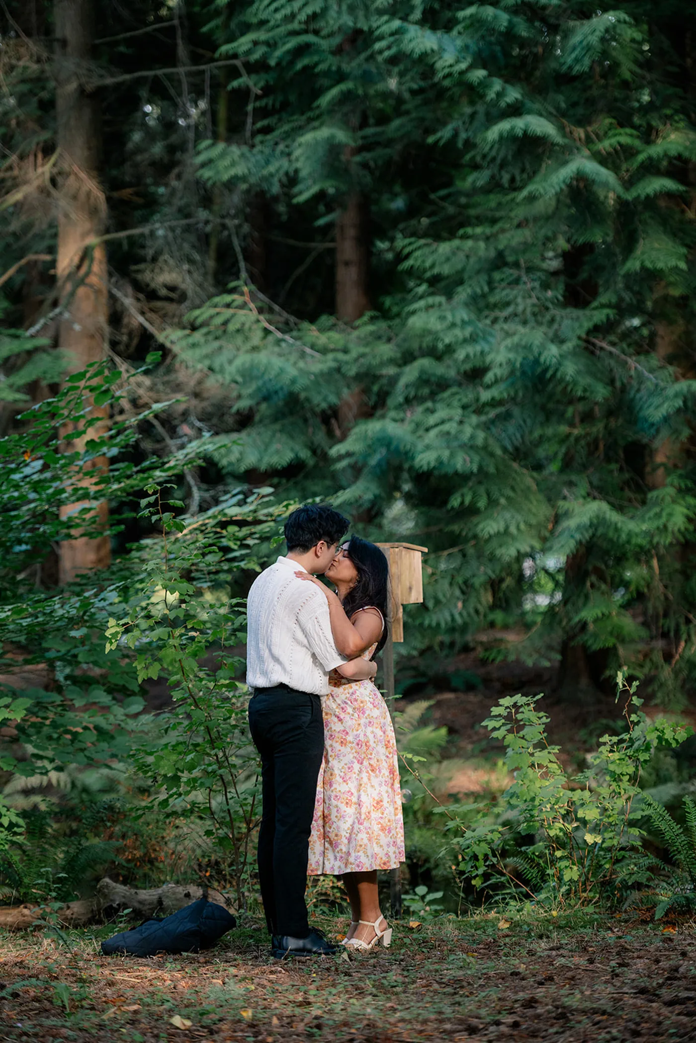 Couple embracing after a surprise engagement at VanDusen Botanical Garden in Vancouver.