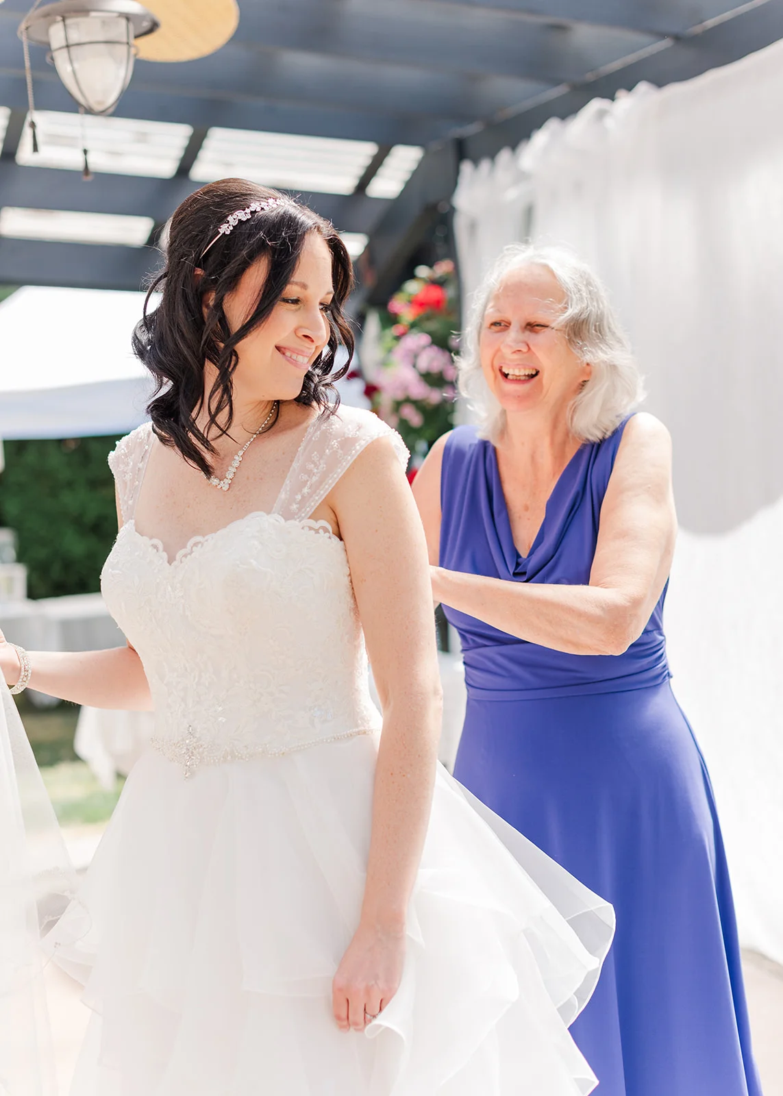 Mom helping daughter get into wedding dress on her wedding day in mission, British Columbia