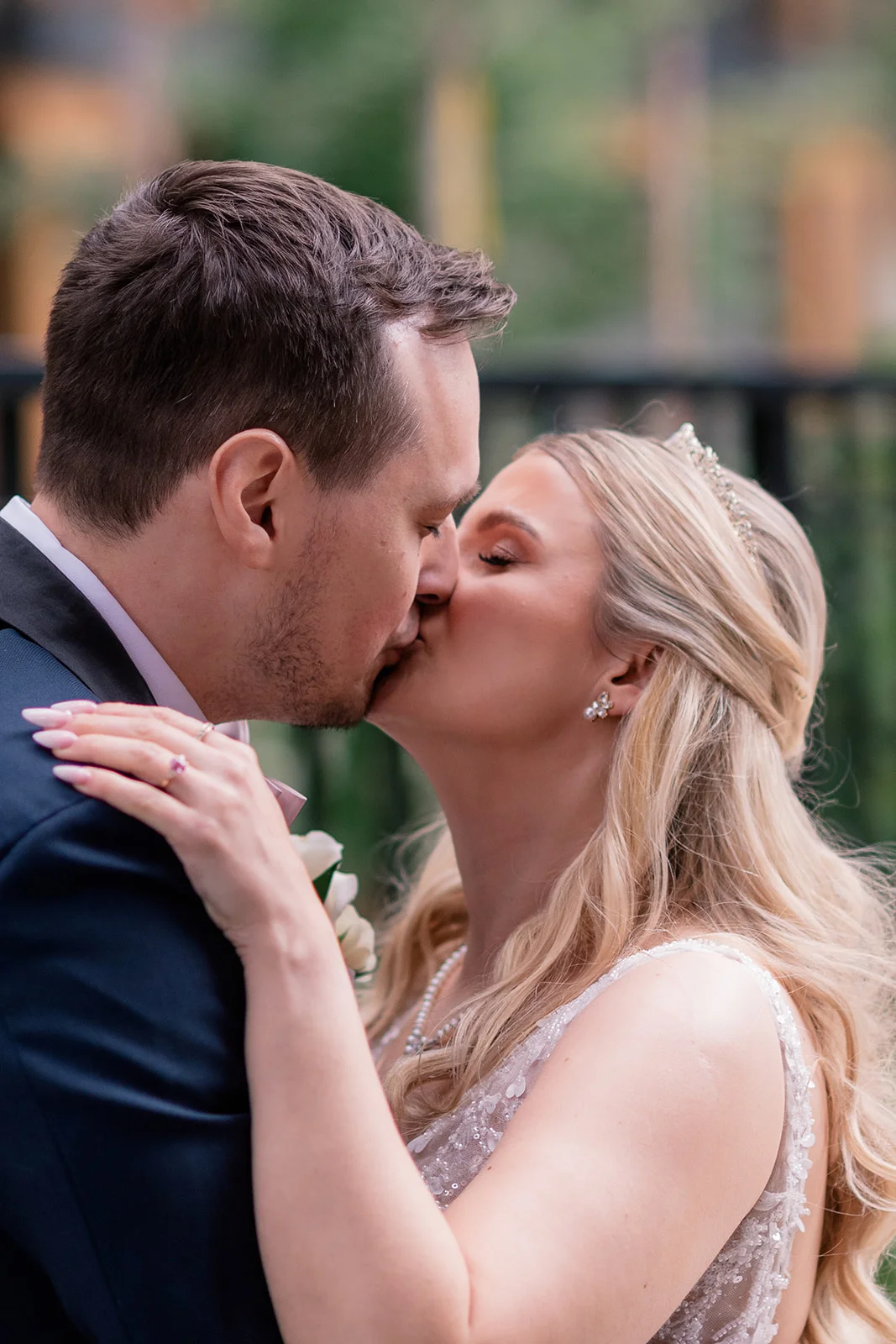 Bride smiling and wiping away tears during the emotional first look with the groom