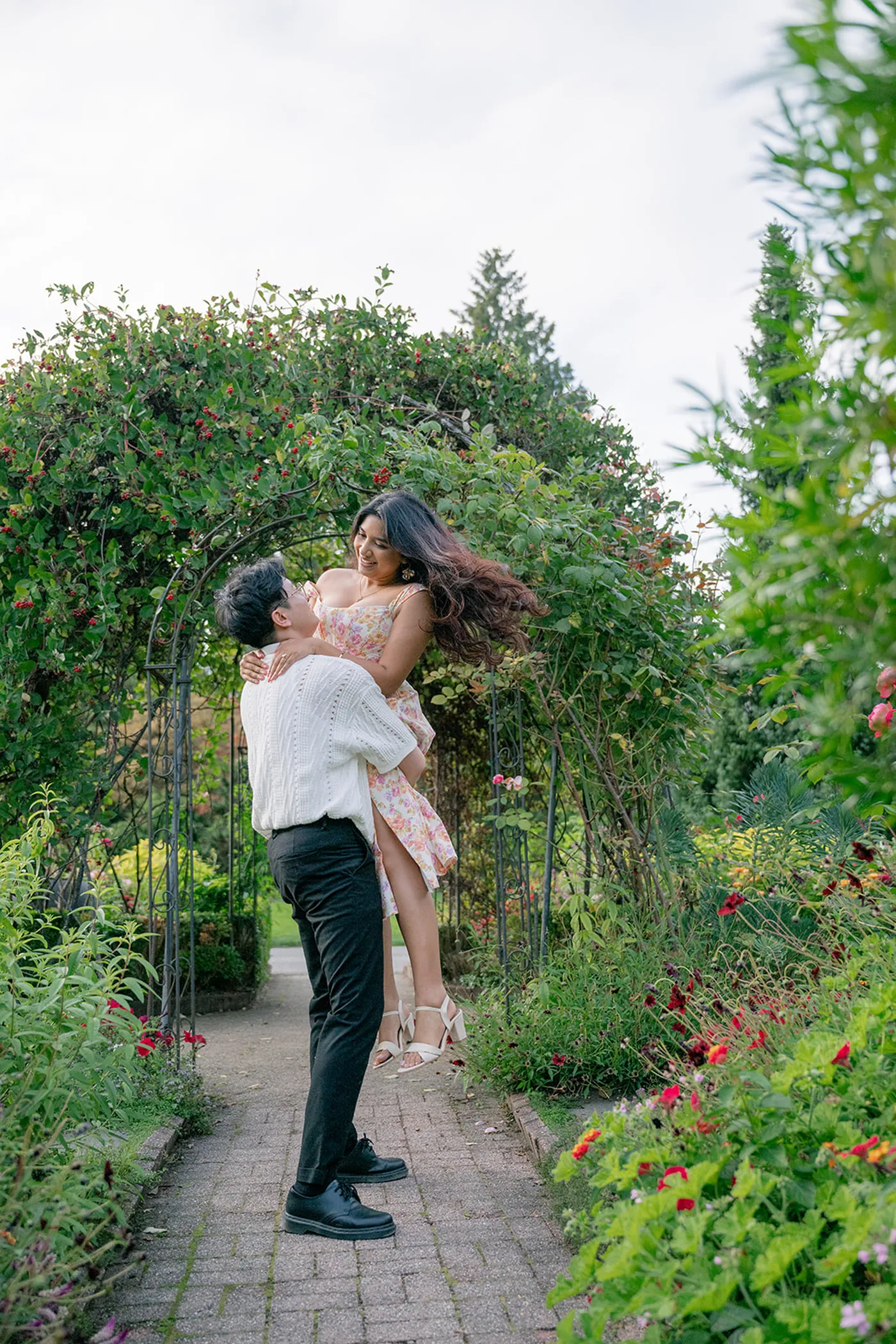 Candid moment of joy after a surprise engagement in VanDusen Botanical Garden, Vancouver.