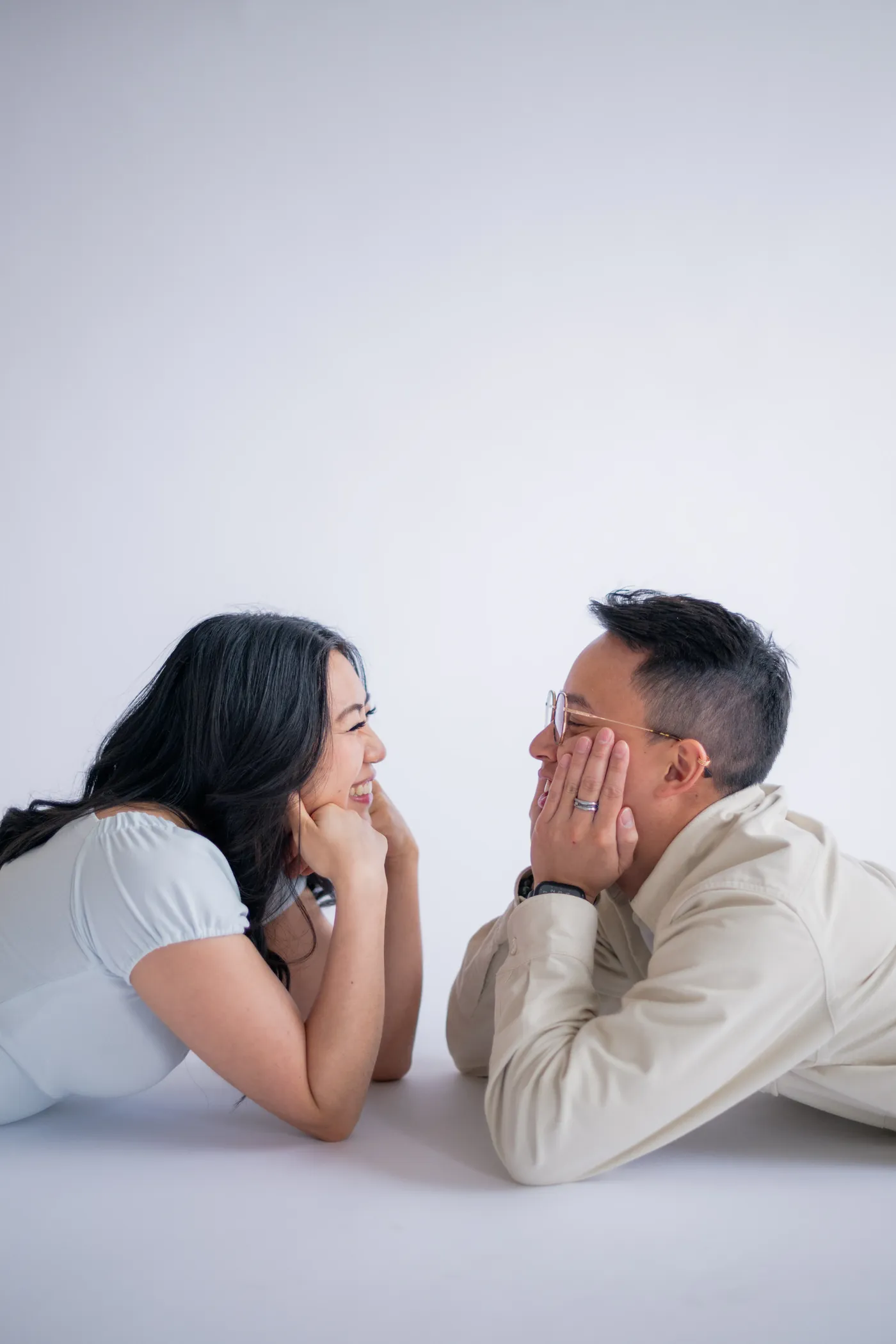 Playful moment captured between a couple leaning into each other, set in a beautiful indoor studio in Vancouver.