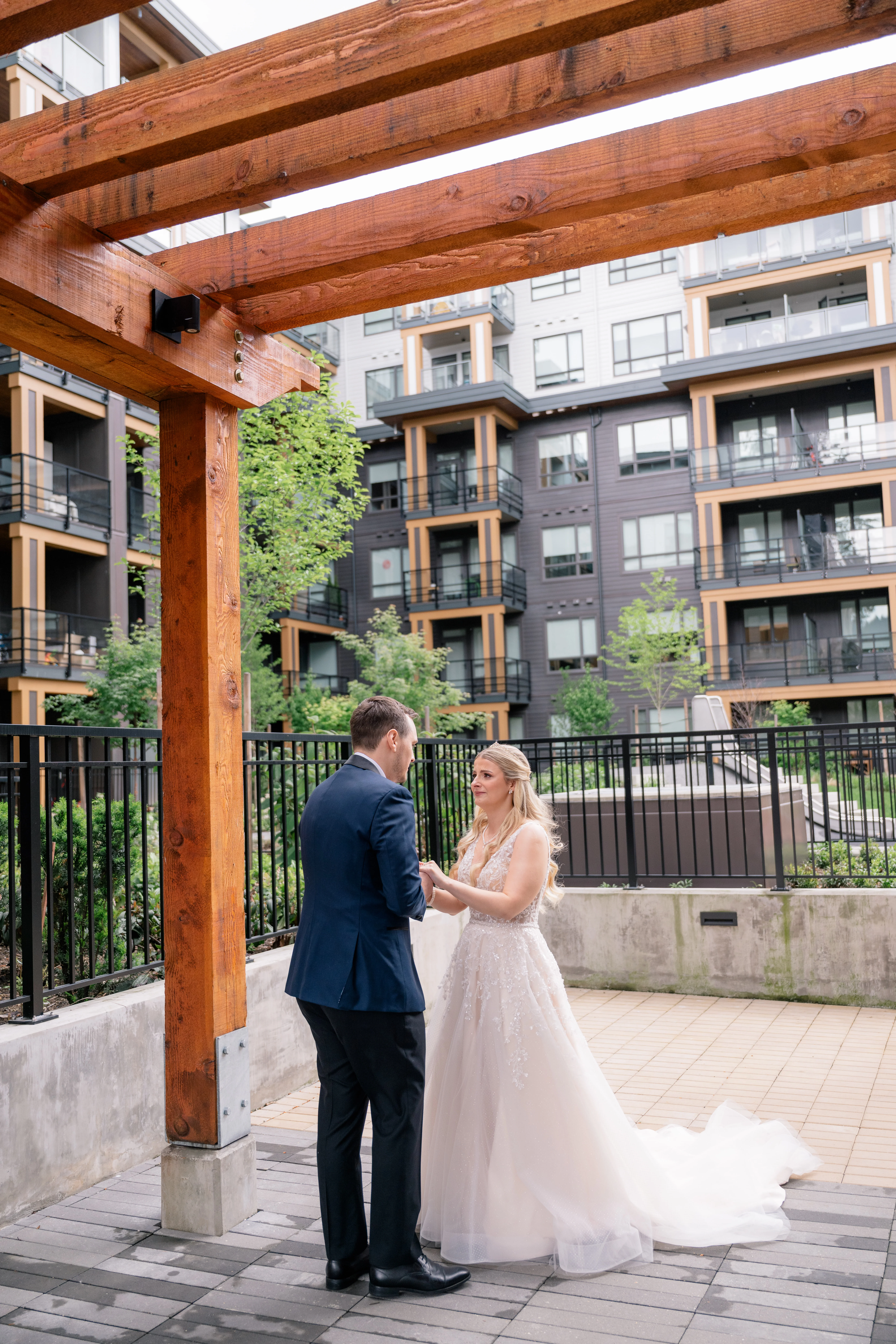 Bride smiling and wiping away tears during the emotional first look with the groom.