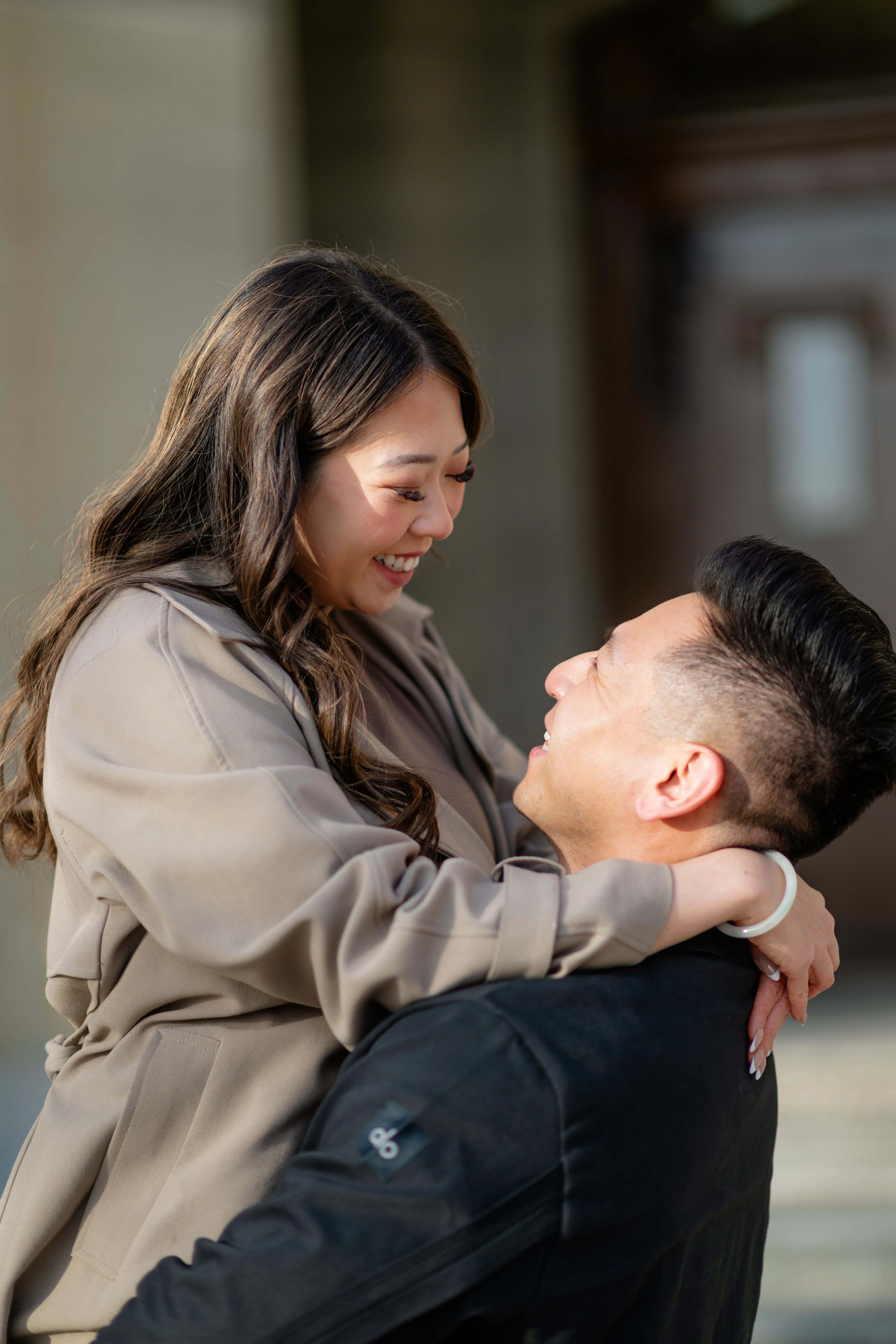 Couple hugging and laughing during engagement photoshoot at Heritage Hall Calgary