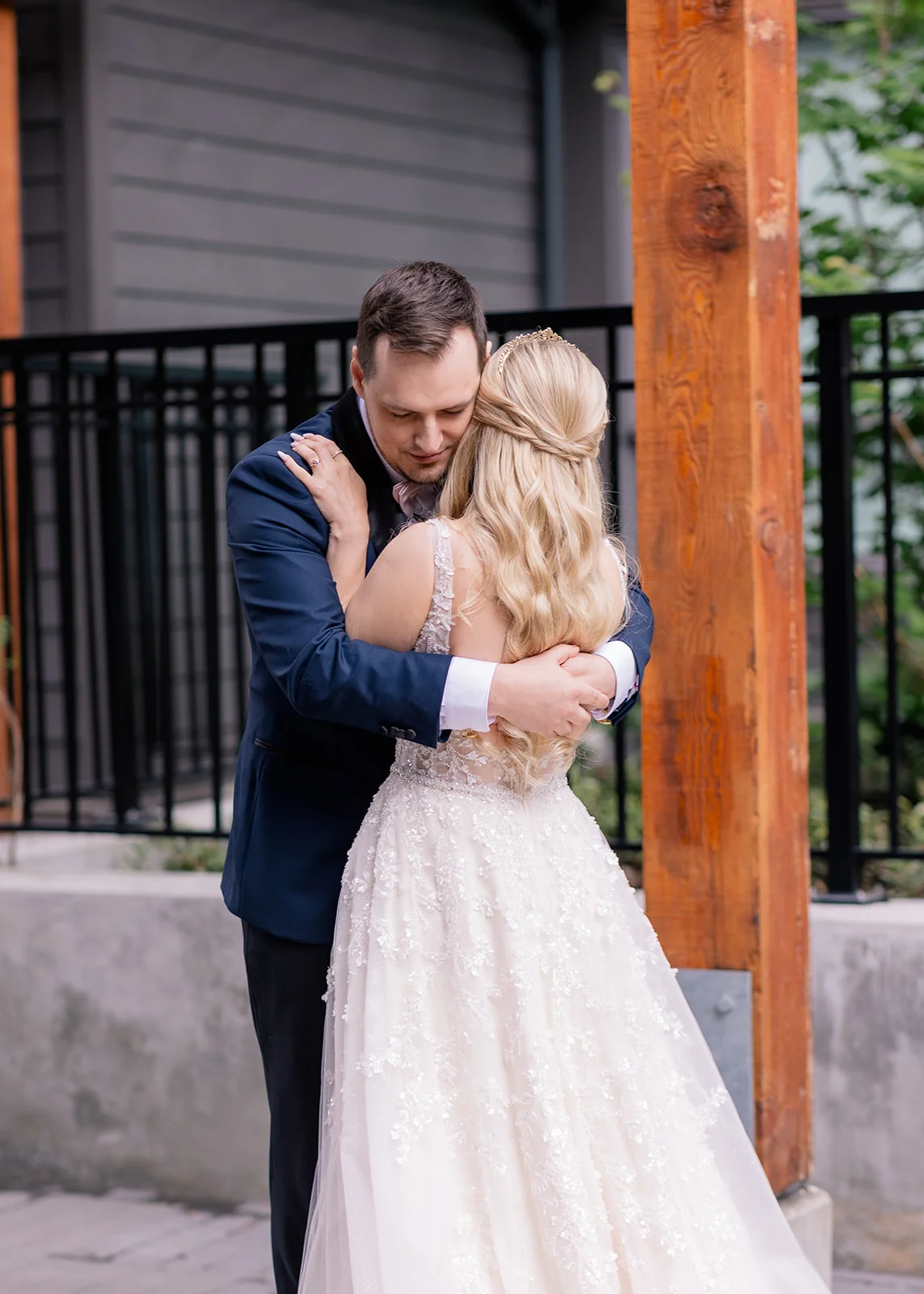 Bride and groom embracing tightly, overwhelmed with emotion during their first look.
