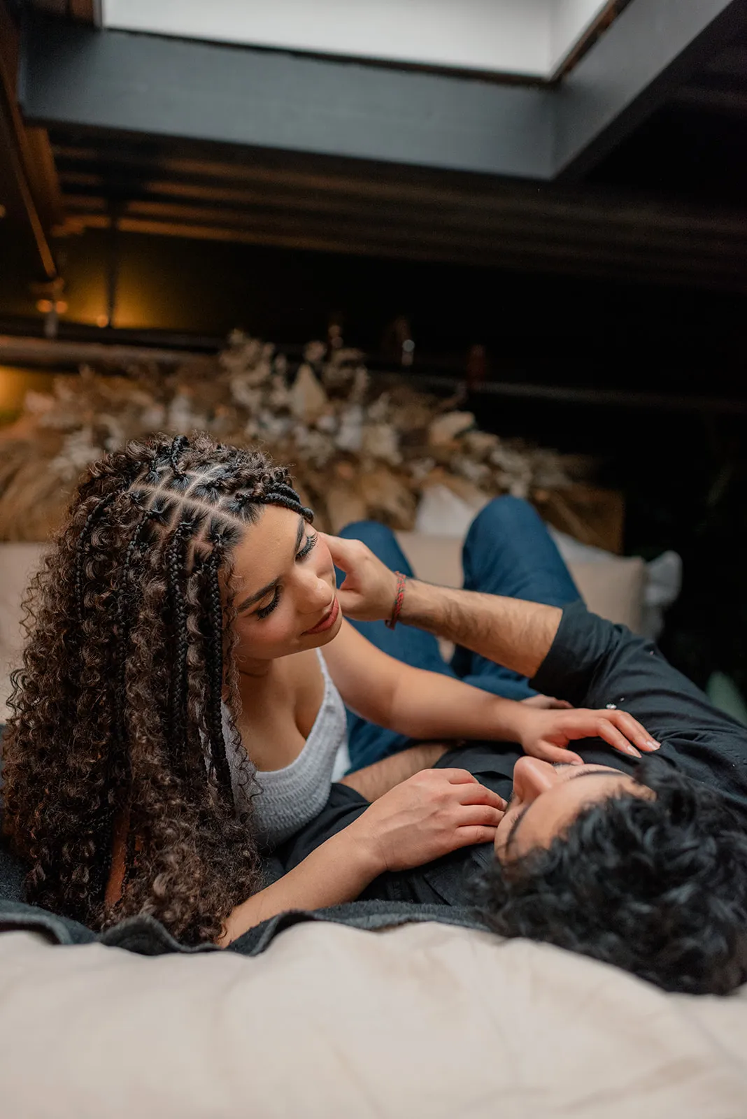 Stylish engagement photo of a couple framed by natural light and plants at Loft Garden Oasis, Vancouver’s top indoor studio