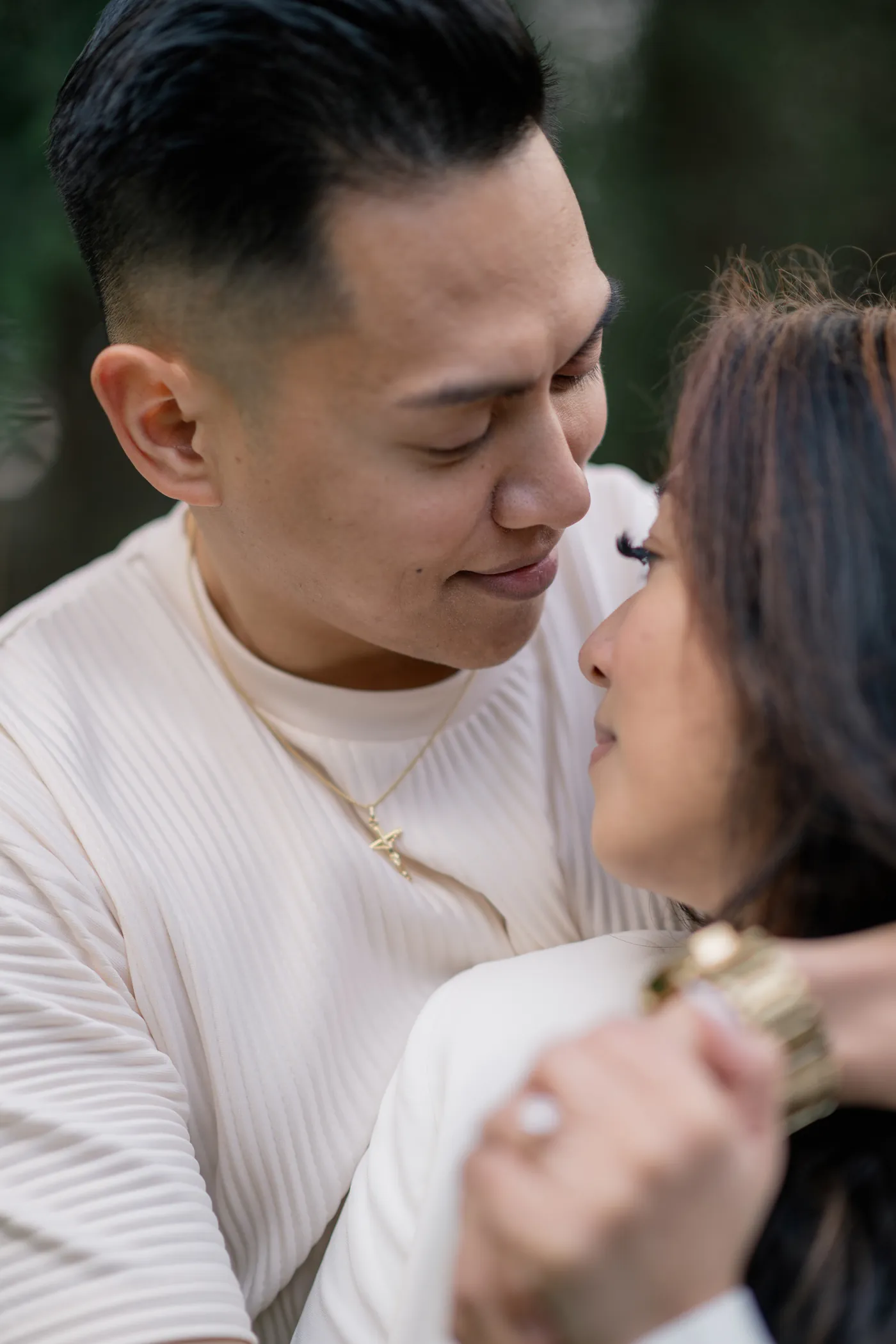 A man and woman holding each other closely, their eyes full of love, at their Vancouver engagement session.