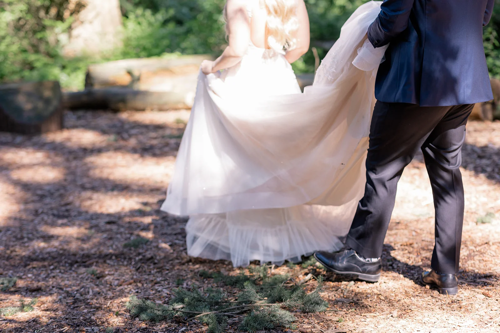 Bride and groom sharing a loving moment amidst the ethereal atmosphere of a forest, capturing the timelessness and wonder of their love story