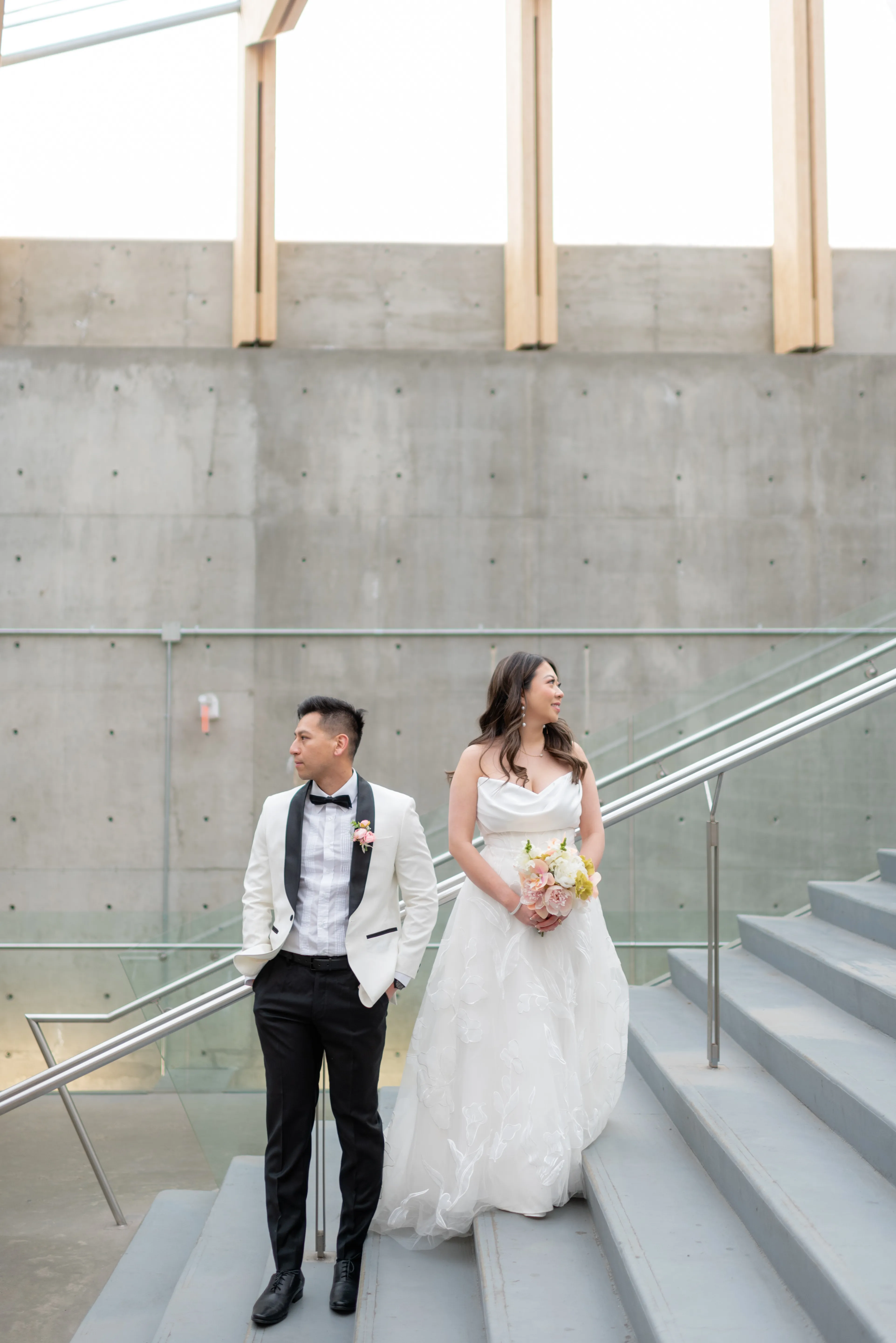 Bride and groom posing together with symmetry and natural light at SAIT Polytechnic Parkade