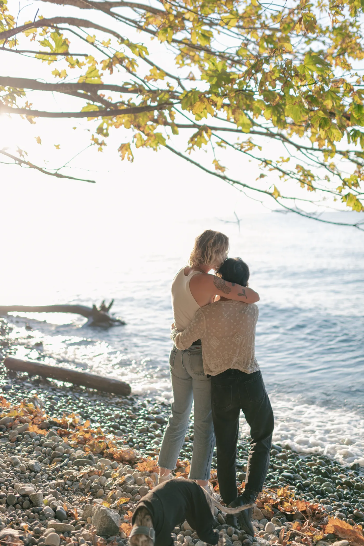A romantic beachside engagement session with an LGBTQ+ couple and their dog. Captured at sunset, this moment showcases love and adventure in Canada.