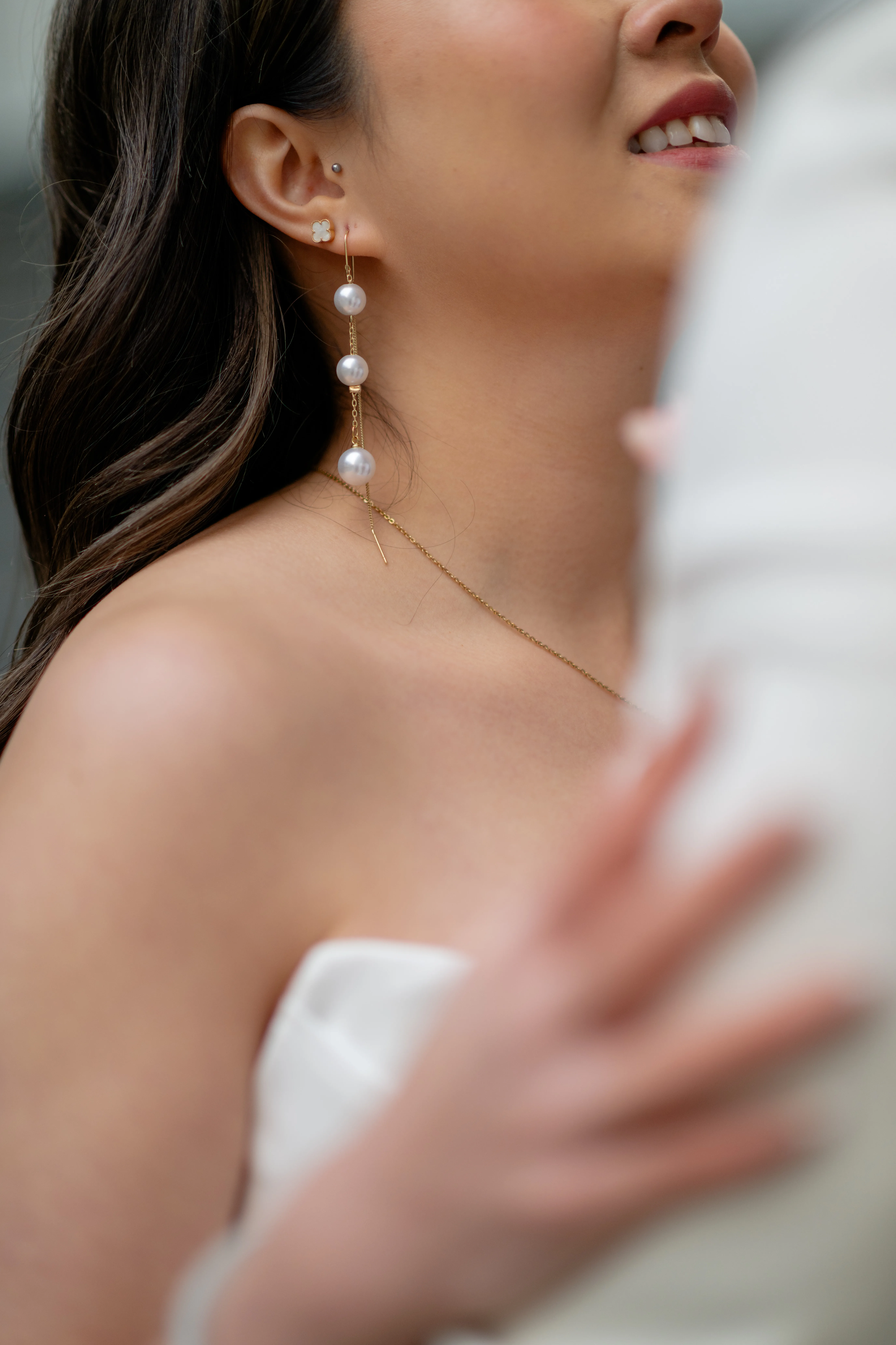 Close-up on bride's earrings on concrete stairs in Calgary parkade