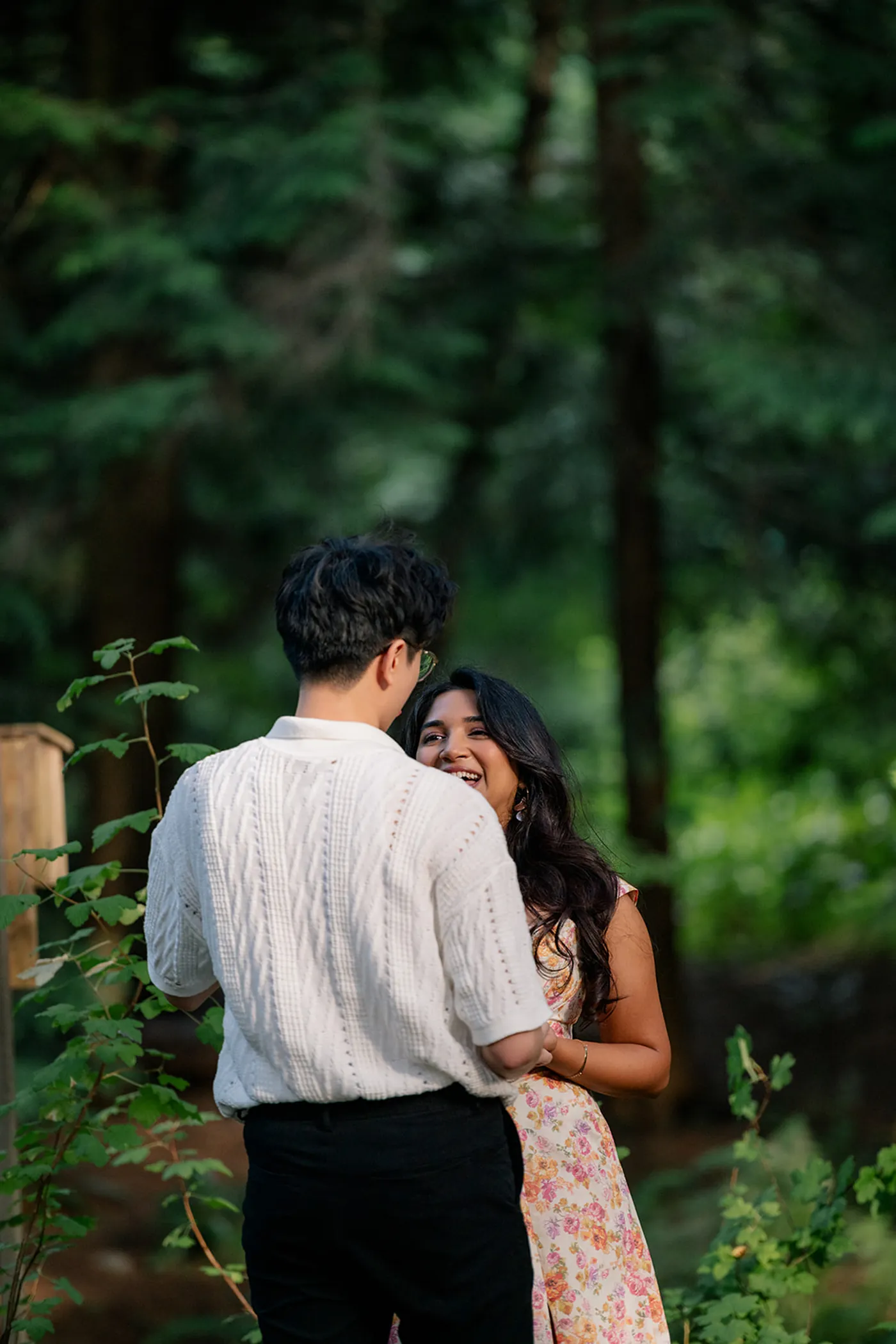 Couple embracing after a surprise engagement at VanDusen Botanical Garden in Vancouver.