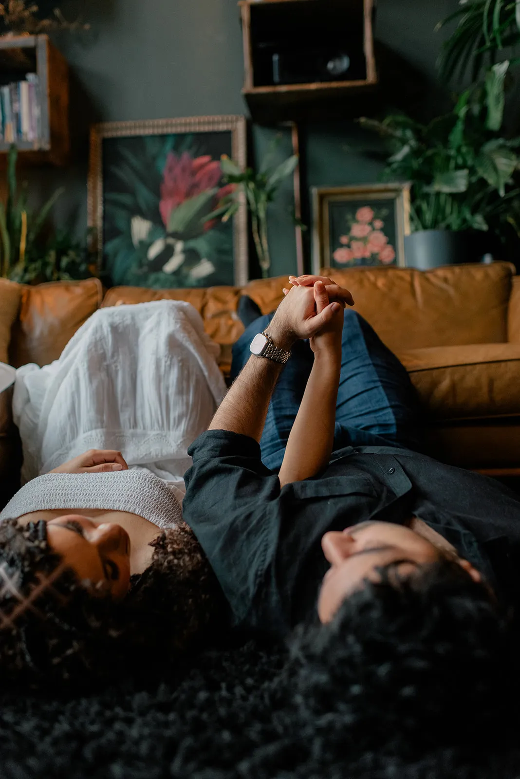 Couple lying together on a textured rug at Loft Garden Oasis, showcasing intimate moments and a cozy Vancouver photoshoot setting.