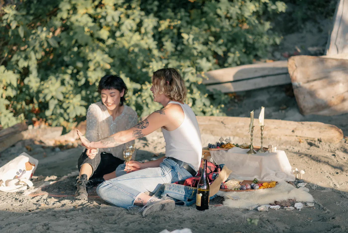 A relaxed and intimate engagement session in a forested area with golden light. A beautiful moment between a same-sex couple captured by a Canadian proposal photographer.
