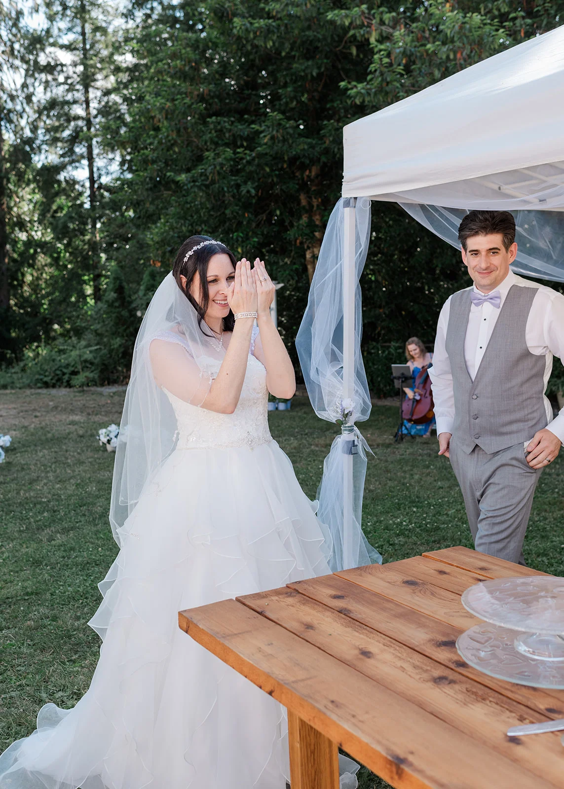 bride and groom reaction to wedding cake summer backyard wedding in mission, british columbia