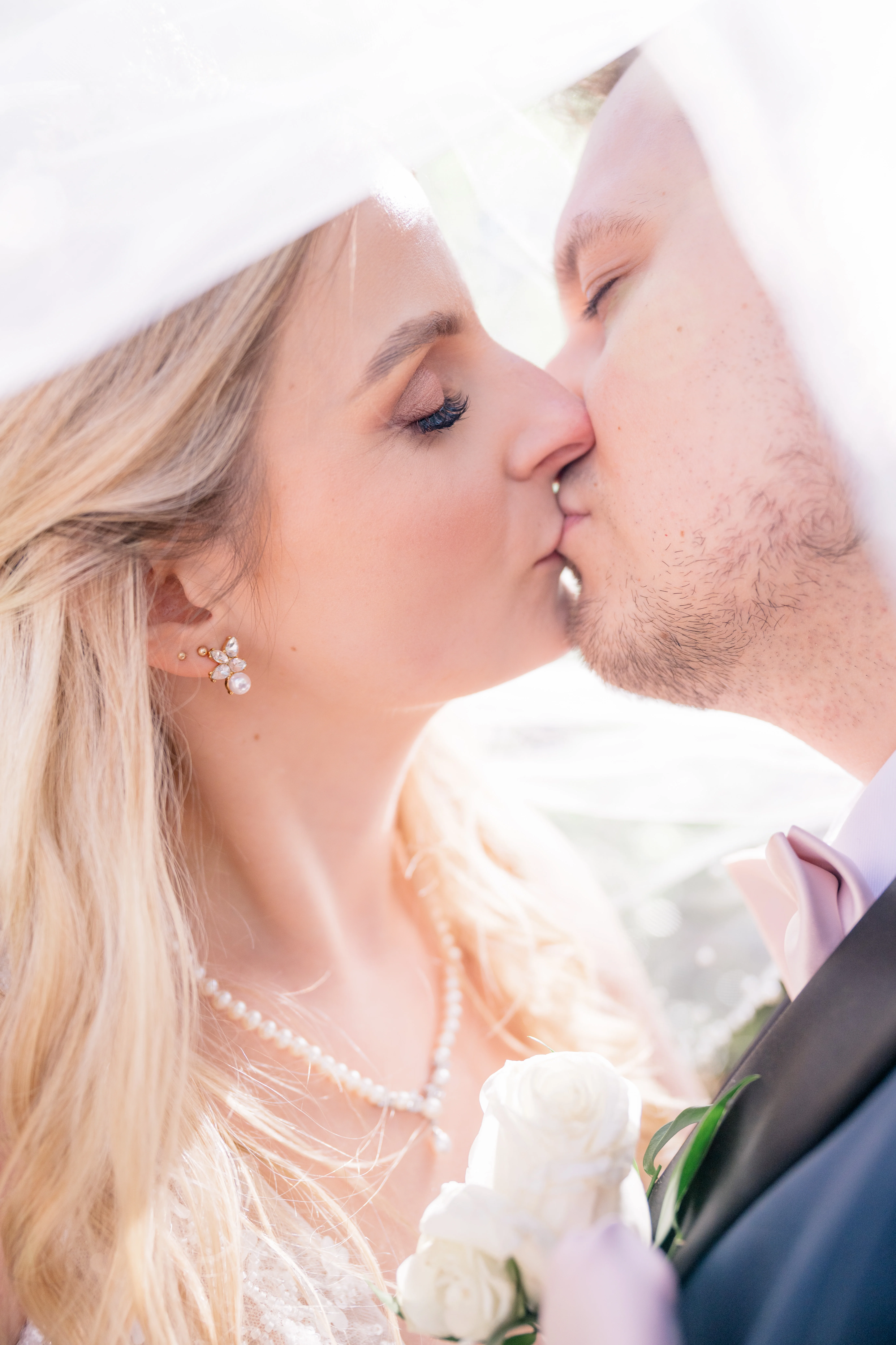 Magical couple portraits in a serene forest setting, with the bride and groom surrounded by towering trees and dappled sunlight