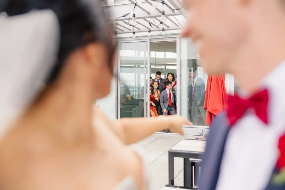 bride and groom smiling at their friends after their first look at hart house in burnaby british columbia