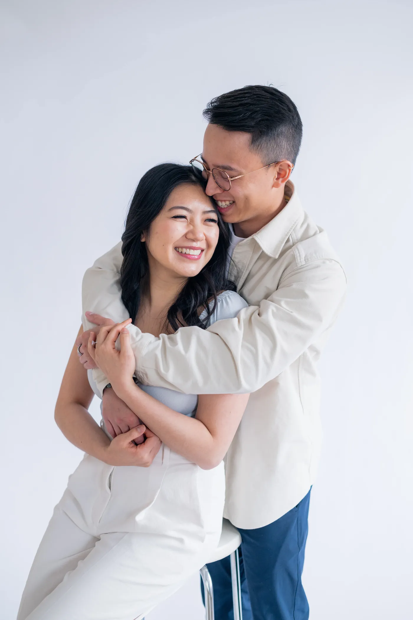 Playful moment captured between a couple leaning into each other, set in a beautiful indoor studio in Vancouver.
