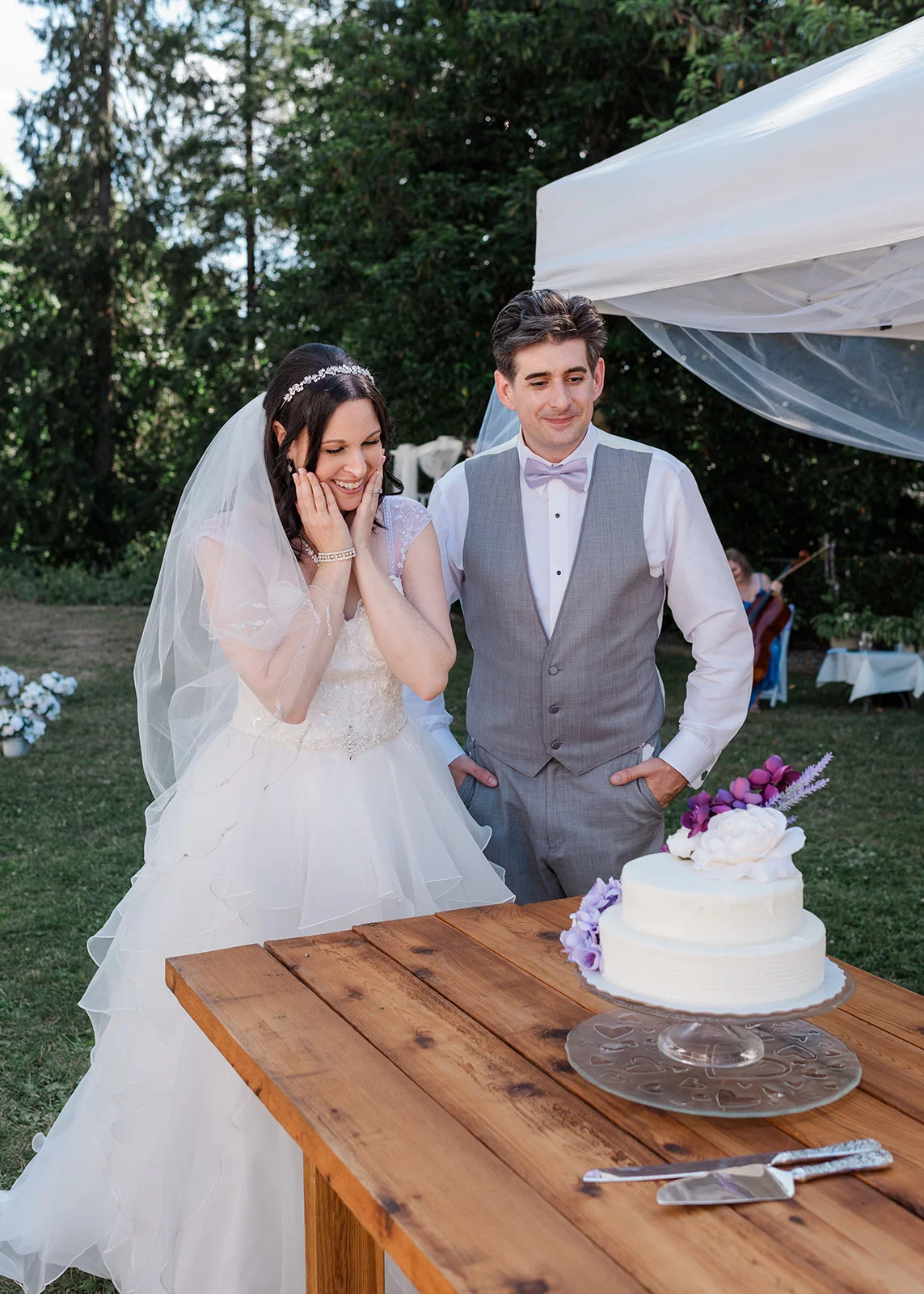 bride and groom reaction to wedding cake summer backyard wedding in mission, british columbia