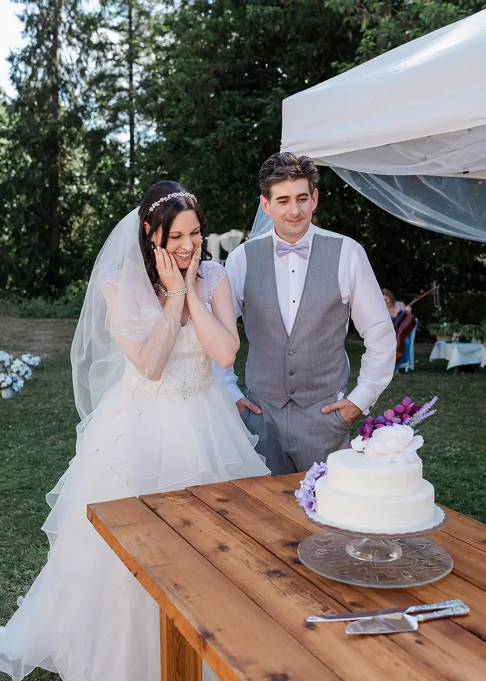 bride and groom reaction to wedding cake summer backyard wedding in mission, british columbia