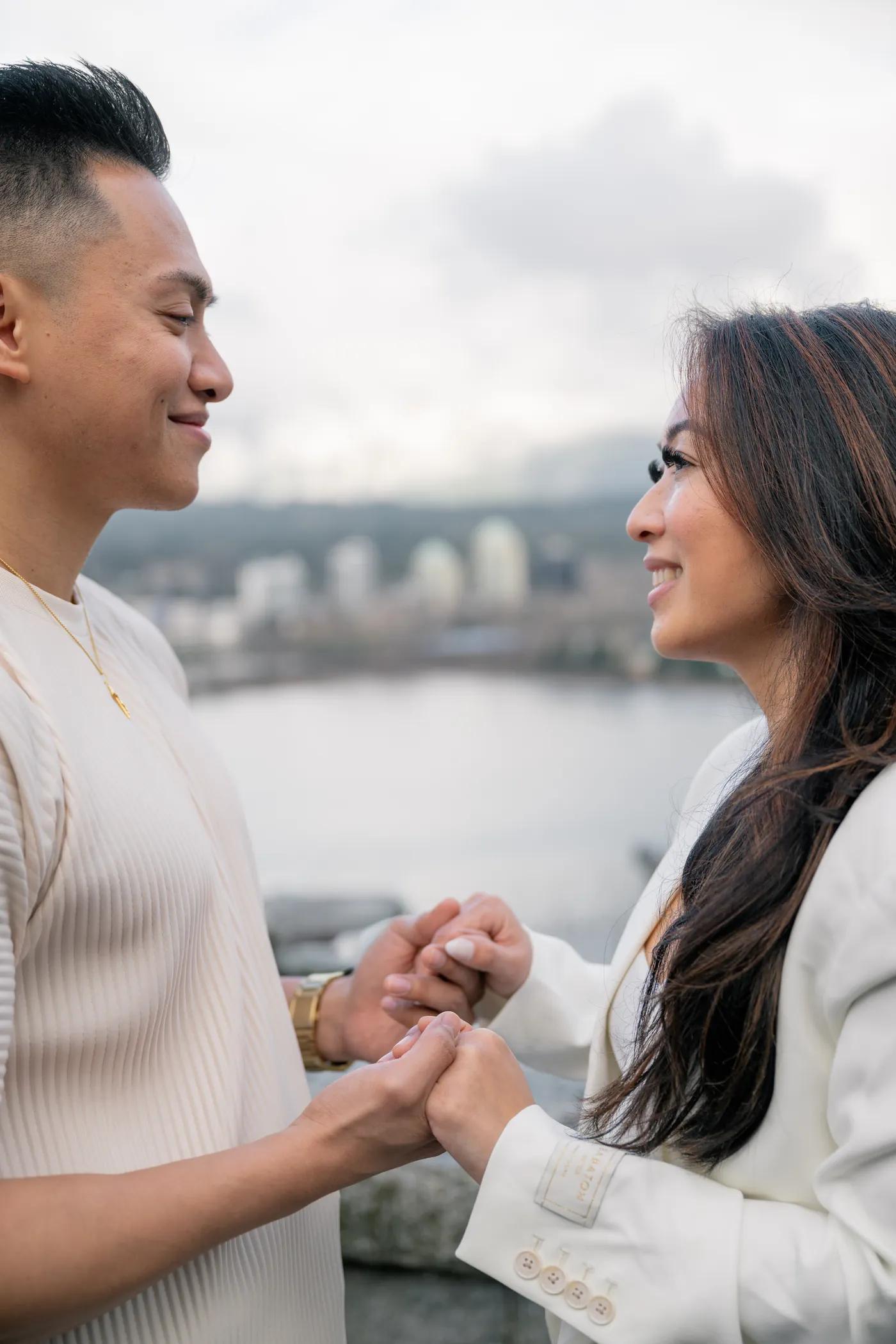 A couple laughs together during their engagement session, capturing their playful and genuine connection.