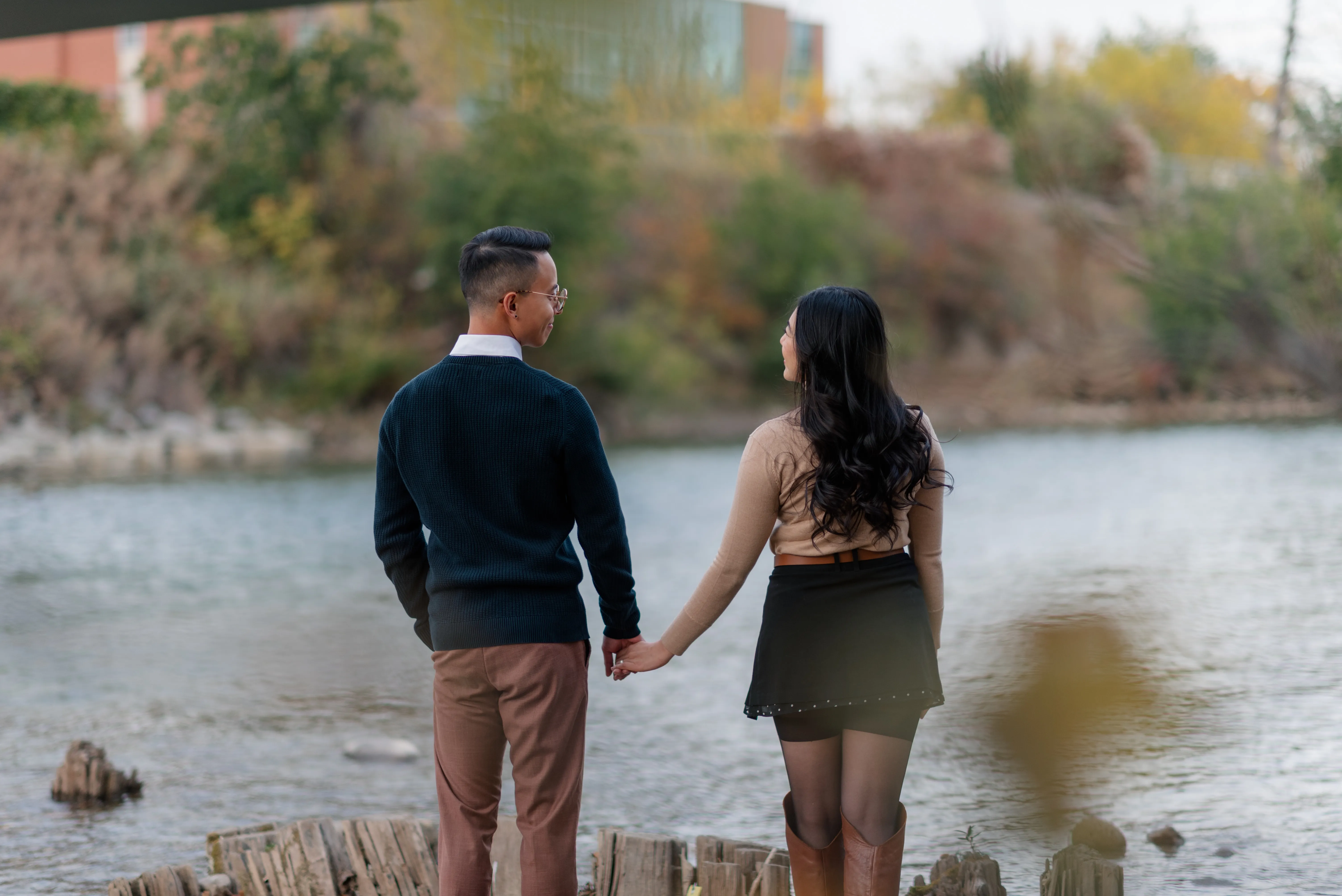 Candid engagement phot of couple holding hands together near Riverdale Avenue Footbridge