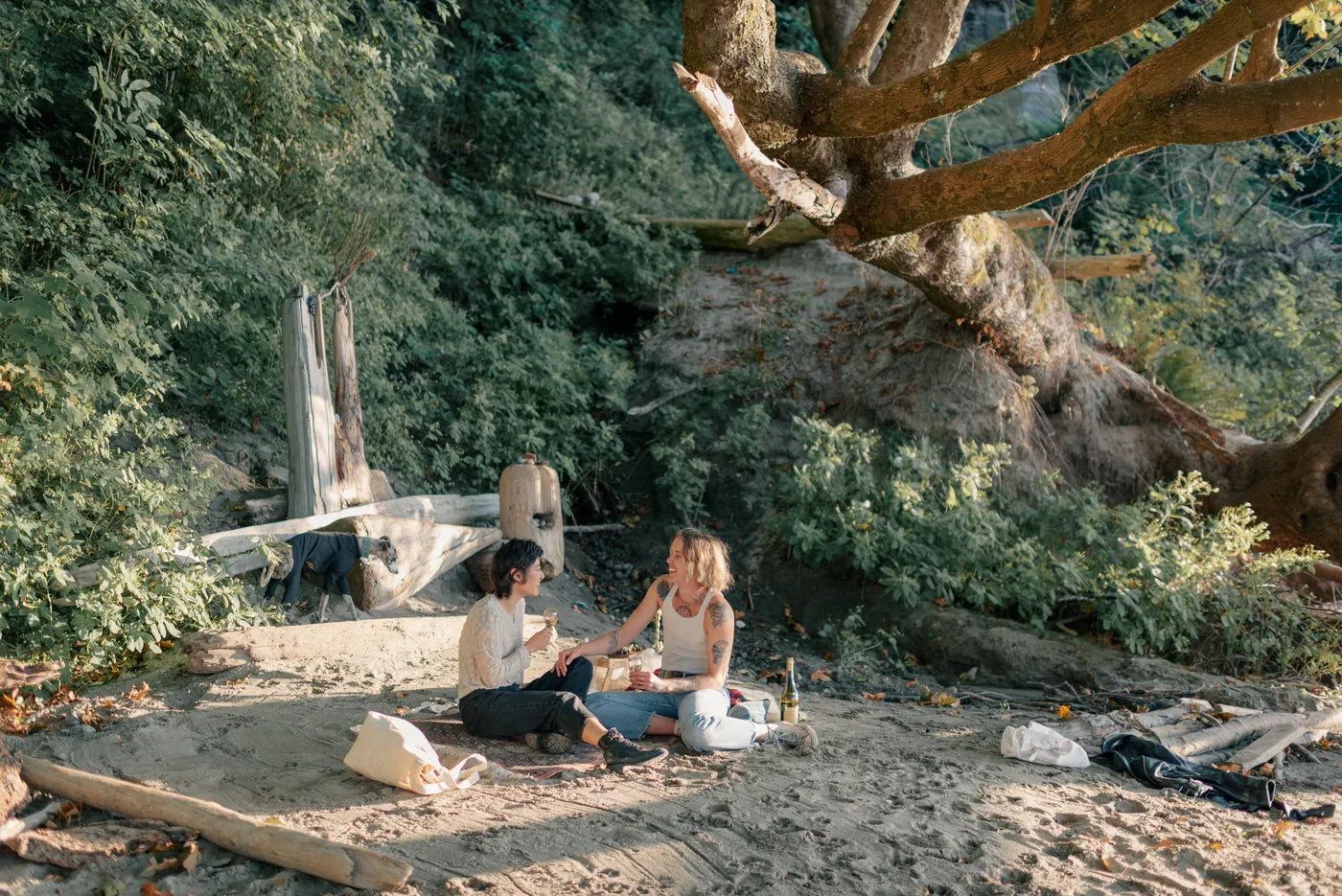 A relaxed and intimate engagement session in a forested area with golden light. A beautiful moment between a same-sex couple captured by a Canadian proposal photographer.