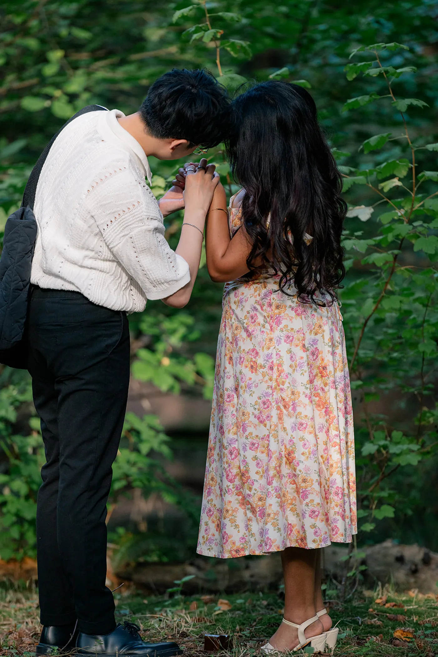 Couple embracing after a surprise engagement at VanDusen Botanical Garden in Vancouver.