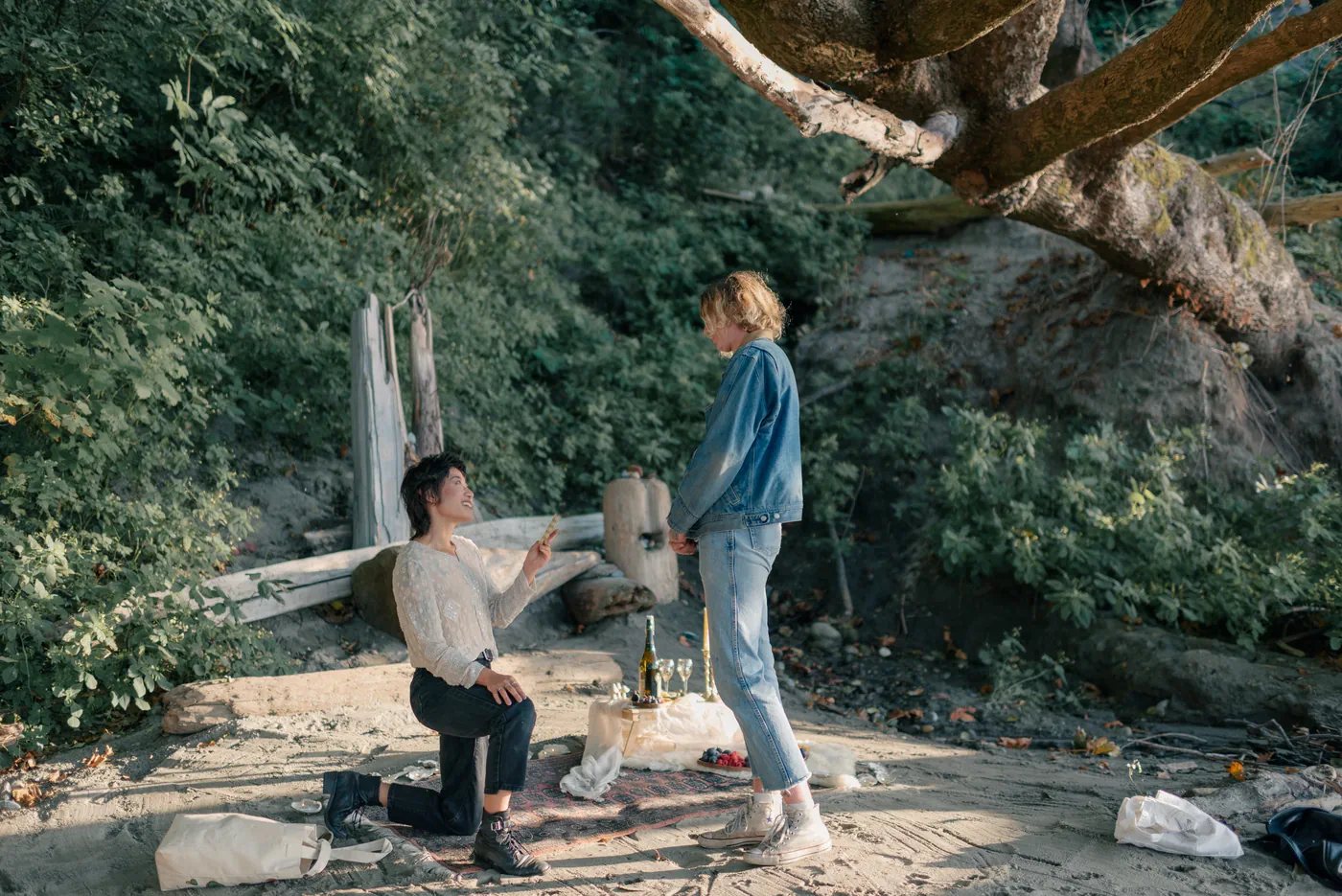 A heartfelt moment as one partner reads a handwritten love note during a surprise proposal in the Canadian outdoors. This intimate proposal was beautifully documented by a queer-friendly engagement photographer in Canada.