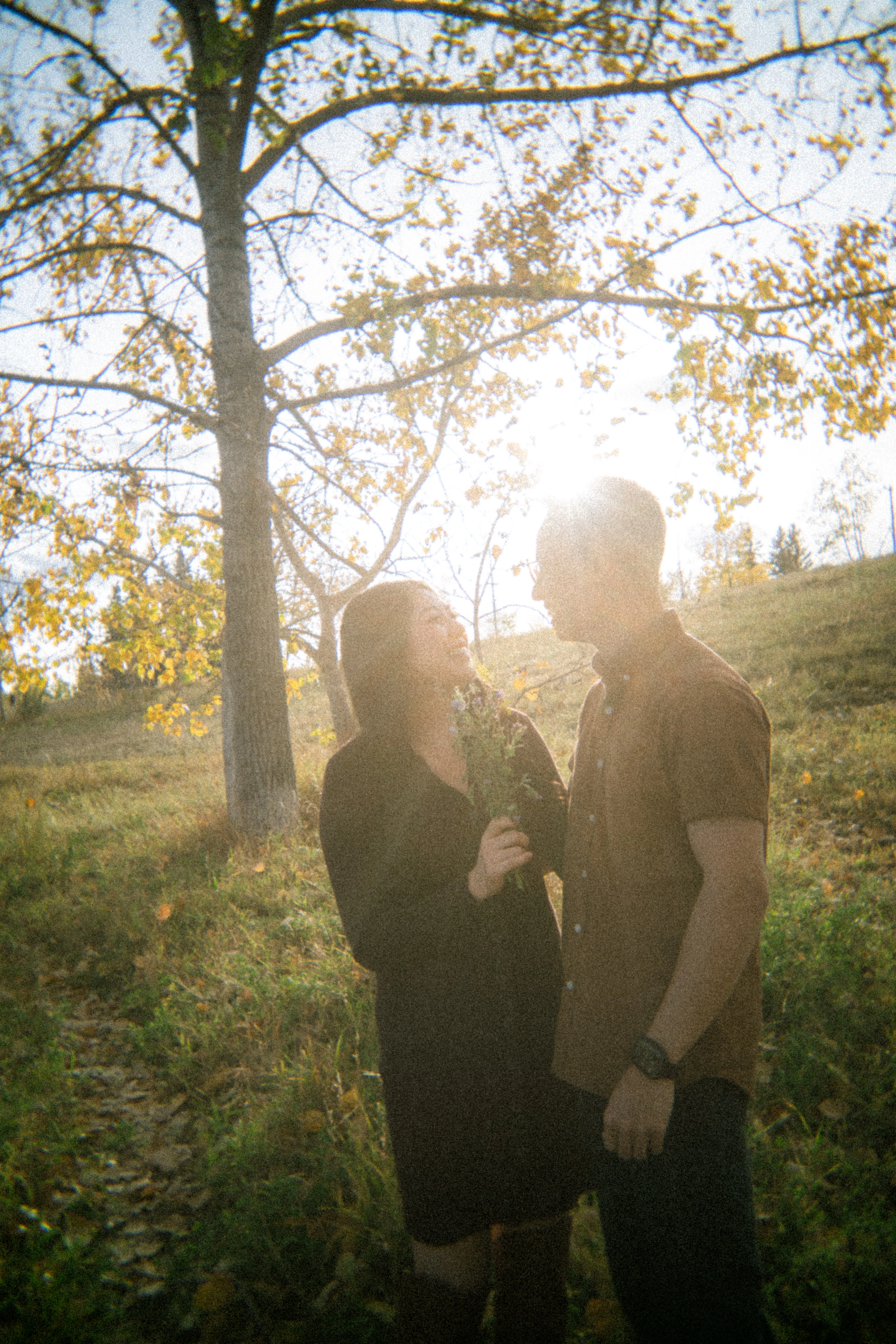 Intimate engagement portrait captured on film at Evamy Ridge overlooking the Elbow River